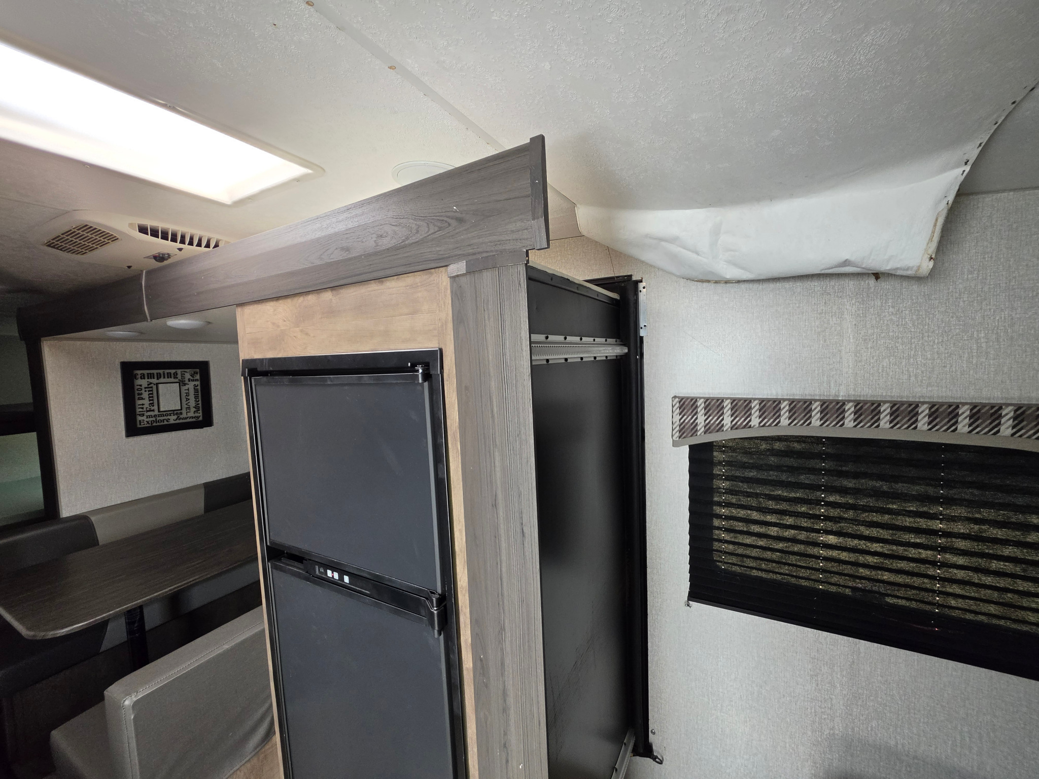 Wide view of ceiling finish hanging near the slide opening and refrigerator