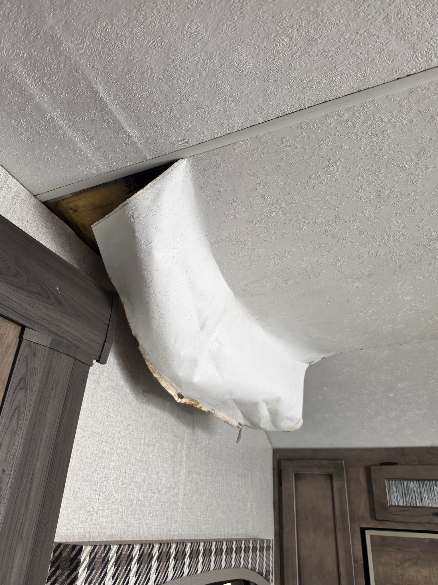 Open ceiling cavity behind detached interior finish